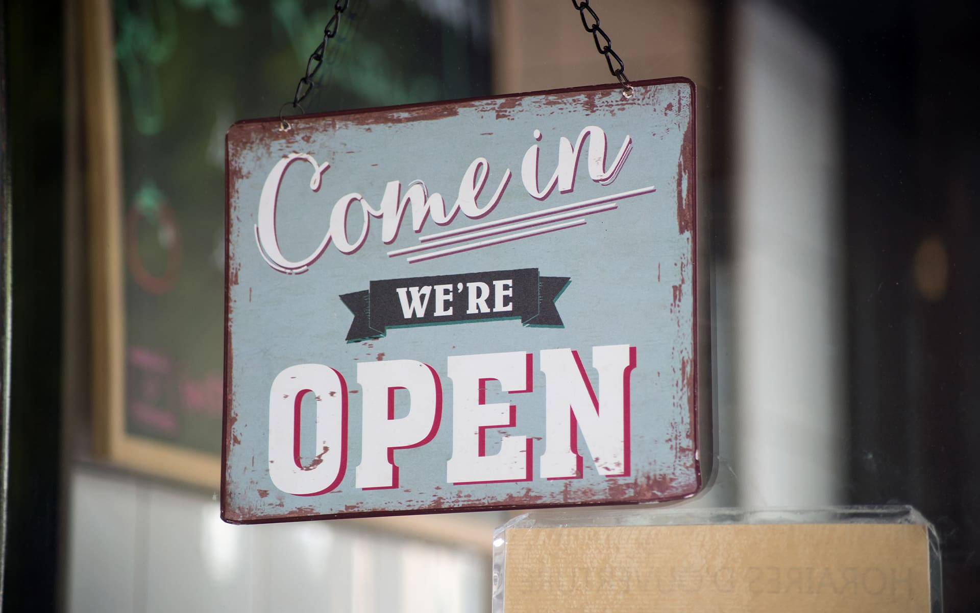 Landing Page - Commercial Quote Open Sign Hanging in Buisness Window